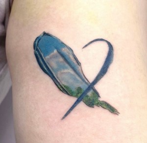 Heart-shaped paint tattoo wiith blue sky, clouds, and green landscape - by Pulmun , Seoul tattoo artist